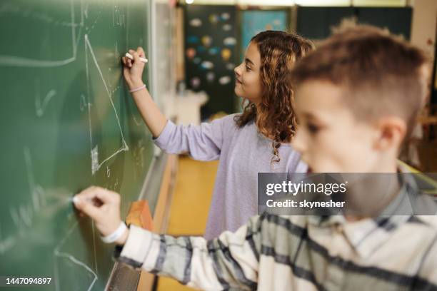 Kid Writing Down Math Math 128 Young Boy Writes Math Equations On Chalkboard Stock Photos, High ...