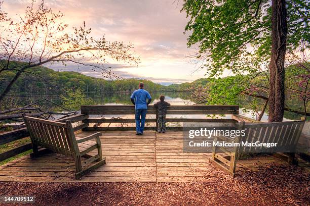 father and son enjoying sunrise - nashville sunrise stock pictures, royalty-free photos & images