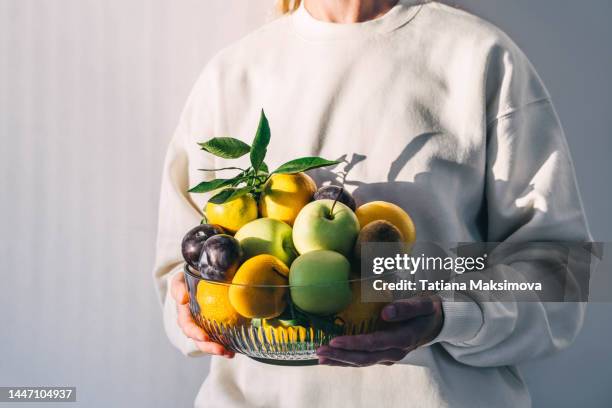 plate with fruits on a white background on a sunny day. - kiwi fruit stock pictures, royalty-free photos & images