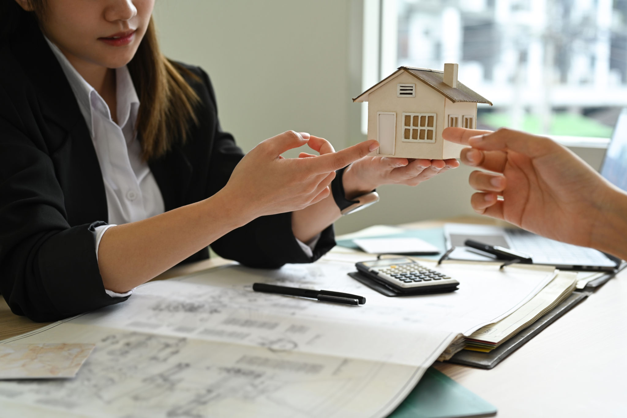 Architect team discussing, inspecting a construction project together during meeting in modern office. Architect team discussing, inspecting a construction project together during meeting in modern office.