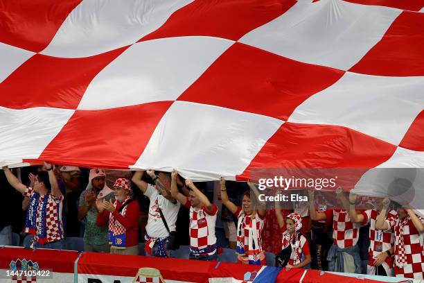 Croatia fans hold a giant Croatia flag before the opening kickoff against Japan during the FIFA World Cup Qatar 2022 Round of 16 match between Japan...