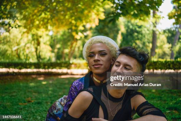 lgbtq male couple hugging each other outdoors - felicidad duran fotografías e imágenes de stock