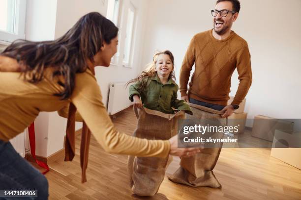 sack race at new apartment! - sack race stock pictures, royalty-free photos & images