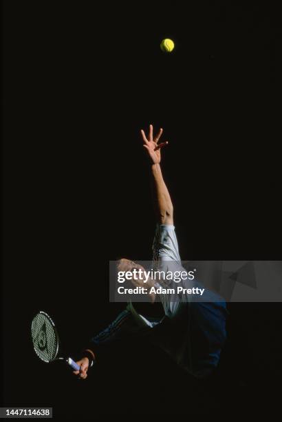 Marat Safin from Russia reaches to serve to compatriot Mikhail Youzhny during their Men's Singles Third Round match at the Australian Open Tennis...