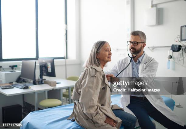 elderly woman at preventive doctors examination. - flu prevention stock pictures, royalty-free photos & images