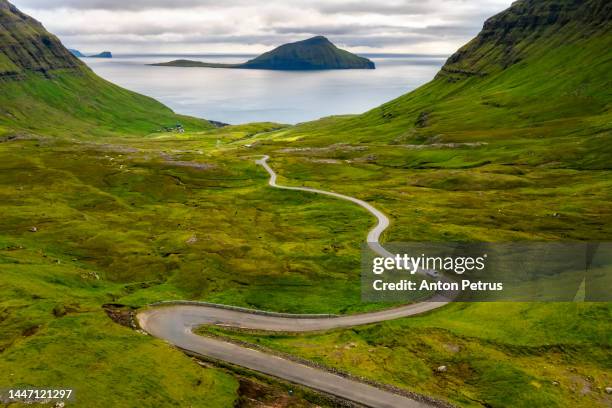 winding road in the mountains. faroe islands, streymoy - faroe islands stock pictures, royalty-free photos & images