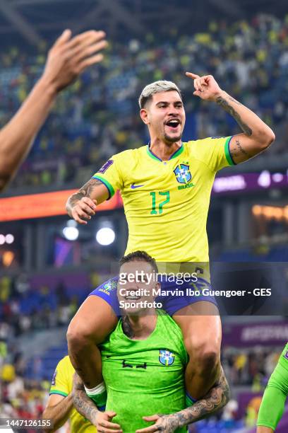 Ederson carries Bruno Guimaraes on his soulder after the FIFA World Cup Qatar 2022 Round of 16 match between Brazil and South Korea at Stadium 974 on...