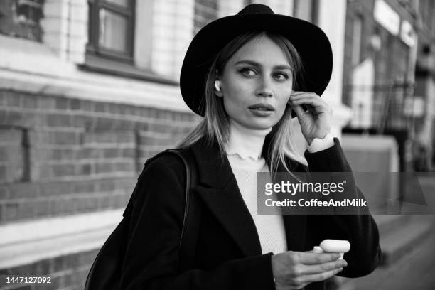 beautiful woman enjoying autumn. black and white photo - close up of beautiful young blonde woman with black hat stock pictures, royalty-free photos & images