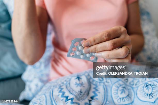 close-up of woman hands with pills. hormone replacement therapy - hot flash stock pictures, royalty-free photos & images