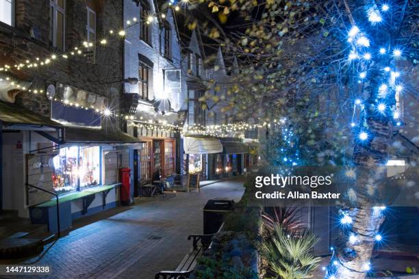 christmas lights along lynmouth high street, devon - exmoor national park night stock pictures, royalty-free photos & images