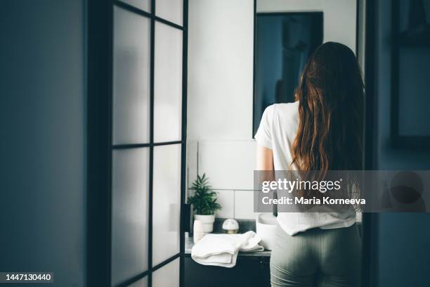 young woman awakening.  woman doing morning routine at the bathroom. - candid beautiful young woman face stock pictures, royalty-free photos & images