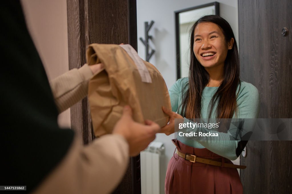 Courier delivering fast food to the customer