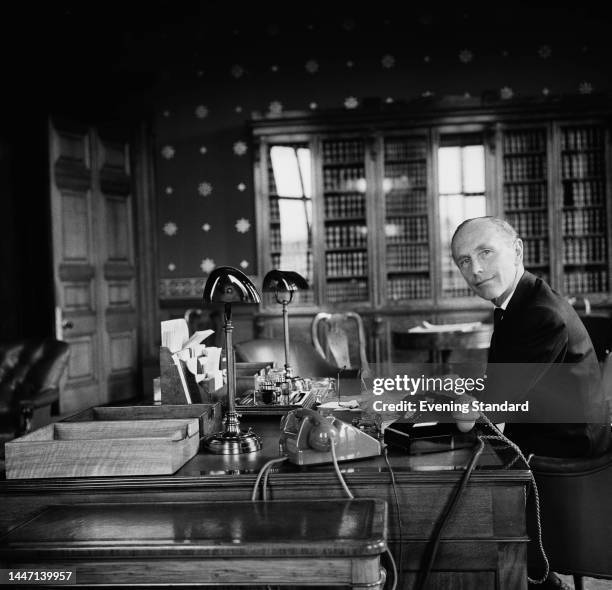 British Conservative politician Alec Douglas-Home, 14th Earl Of Home , pictured at his desk in the Foreign Office in Westminster, London, on July...