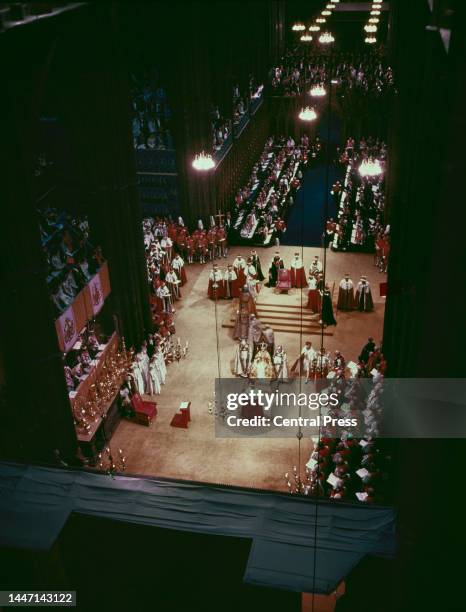 High angle view of the coronation of British Royal Queen Elizabeth II , flanked by British Anglican bishop Michael Ramsey , Bishop of Durham, and...