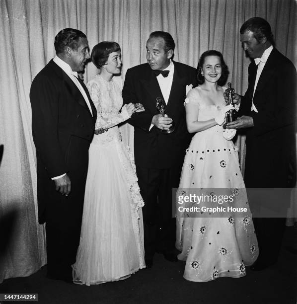 American actor, film director, and film producer Dick Powell and his wife, American actress June Allyson , American actor Broderick Crawford ,...