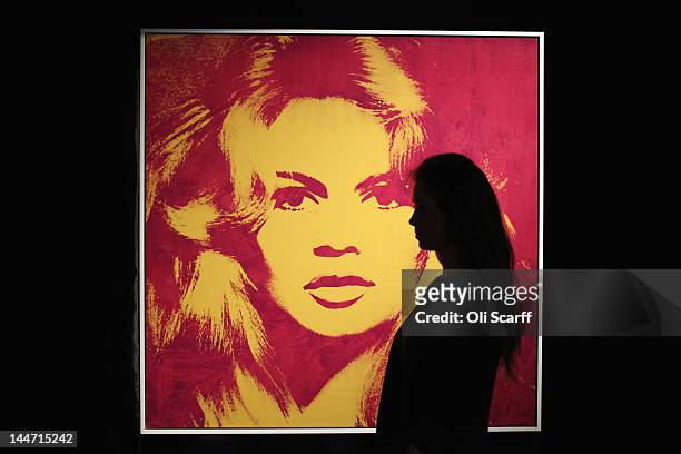 Woman in Sotheby's auction house views an artwork by Andy Warhol entitled 'Brigitte Bardot' with is expected to fetch 4 million GBP on May 18, 2012...