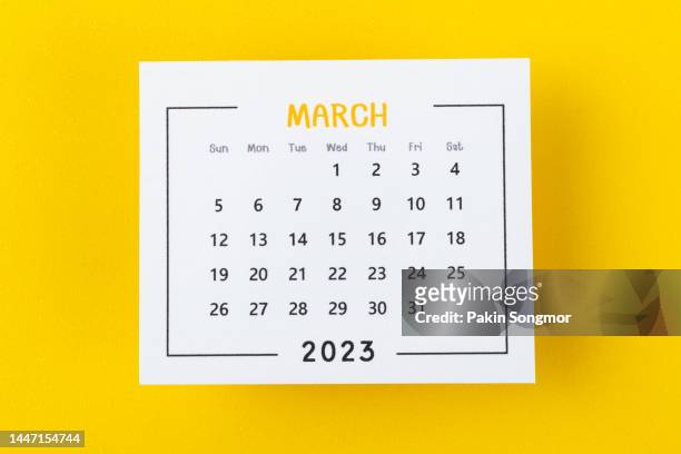 calendar desk 2023: march is the month for the organizer to plan and deadline with a yellow paper background. - marzo fotografías e imágenes de stock