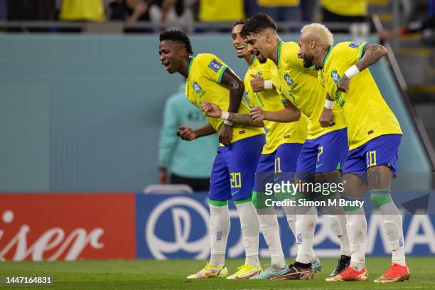 Neymar of Brazil dancing with Lucas Paqueta, Raphinha and Vinicius Junior of Brazil as he celebrates scoring a penalty during the FIFA World Cup...