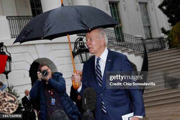 President Joe Biden briefly speaks with reporters in the rain as he departs the White House on December 06, 2022 in Washington, DC. Biden is...