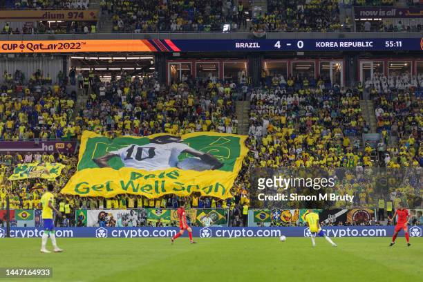 Brazil fans display a giant Get Well Soon Pele flag in the stands during the FIFA World Cup Qatar 2022 Round of 16 match between Brazil and South...