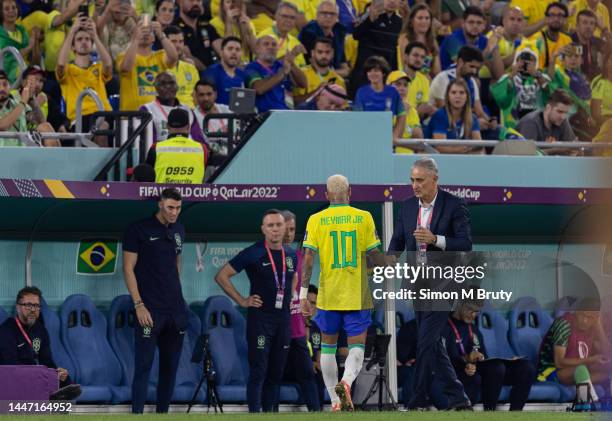Neymar of Brazil shakes hands with Brazil Manager Tite after being substituted during the FIFA World Cup Qatar 2022 Round of 16 match between Brazil...
