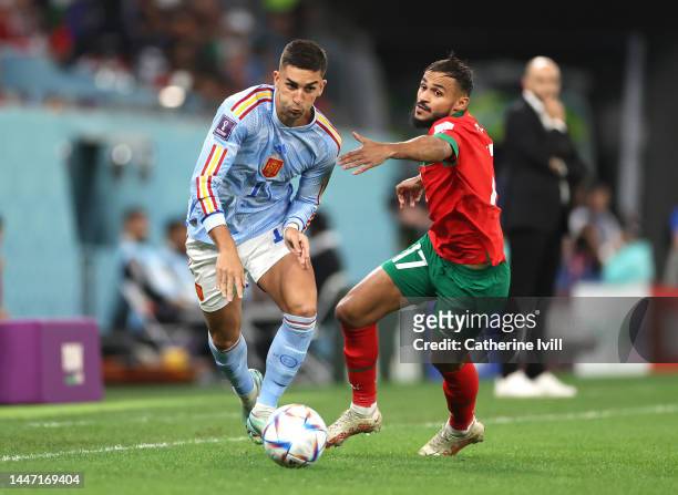 Ferran Torres of Spain is challenged by Sofiane Boufal of Morocco during the FIFA World Cup Qatar 2022 Round of 16 match between Morocco and Spain at...
