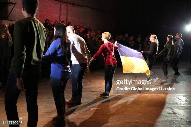 Actors came on stage at the end of a performance, holding the Ukrainian flag in their hands on December 2, 2022 in Odesa, Ukraine. The premiere of a...