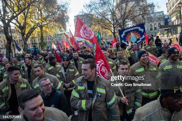 Several thousand firefighters march from their rally at Methodist Central Hall to parliament to lobby their MPs on December 6, 2022 in London,...