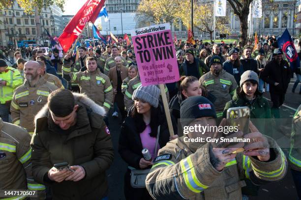Several thousand firefighters march from their rally at Methodist Central Hall to parliament to lobby their MPs on December 6, 2022 in London,...