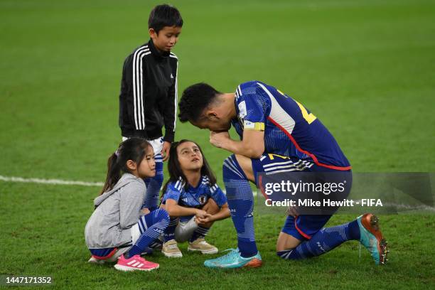 Maya Yoshida of Japan is comforted by his children on the pitch after Japan's elimination in the FIFA World Cup Qatar 2022 Round of 16 match between...