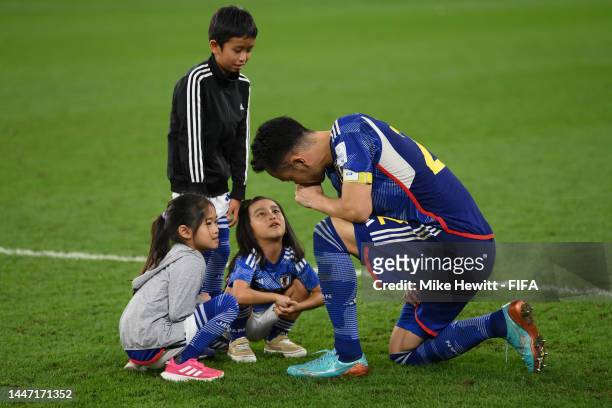 Maya Yoshida of Japan is comforted by his children on the pitch after Japan's elimination in the FIFA World Cup Qatar 2022 Round of 16 match between...