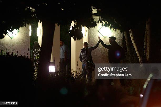 Two Facebook employees share a high five outside of Facebook headquarters May 18, 2012 in Menlo Park, California. The eight-year-old social network...