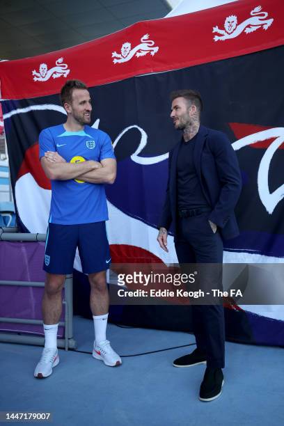 Former England player David Beckham talks to Harry Kane of England following a training session at Al Wakrah Stadium on November 23, 2022 in Doha,...