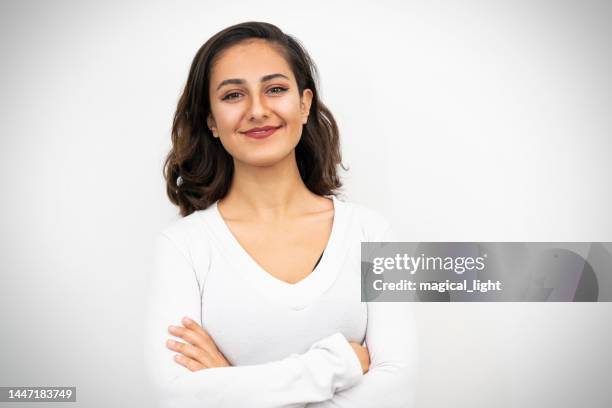 close up portrait of young adult middle eastern woman with white background. - arab woman studio stock pictures, royalty-free photos & images