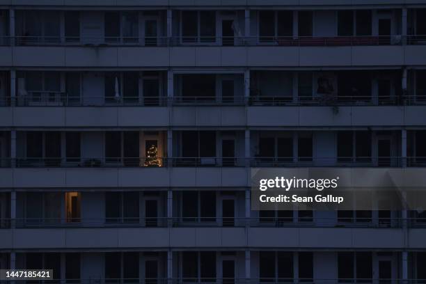Christmas tree stands in a mostly darkened residential apartment buildings in the city center on December 06, 2022 in Berlin, Germany. Germany, which...