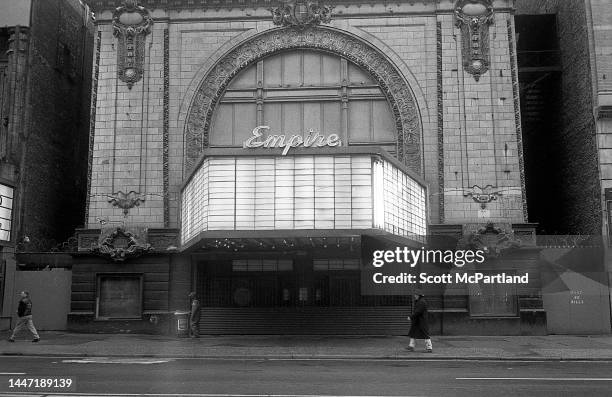 Exterior view of the shuttered Empire Theater on West 42nd Street in Times Square, New York, New York, October 4, 1996. Visible on either side of the...