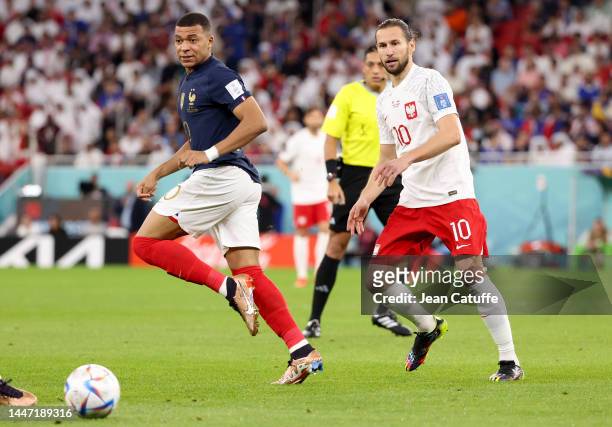 Kylian Mbappe of France, Grzegorz Krychowiak of Poland during the FIFA World Cup Qatar 2022 Round of 16 match between France and Poland at Al Thumama...