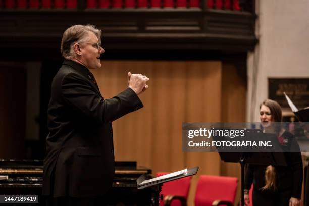 church choir conductor during concert performance - choir stage stock pictures, royalty-free photos & images