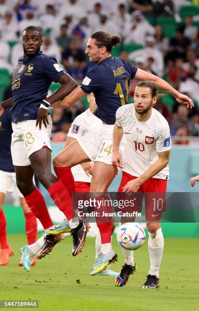 Dayot Upamecano, Adrien Rabiot of France, Grzegorz Krychowiak of Poland during the FIFA World Cup Qatar 2022 Round of 16 match between France and...