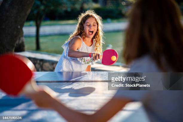 girls playing table tennis on summer day - table tennis stock pictures, royalty-free photos & images