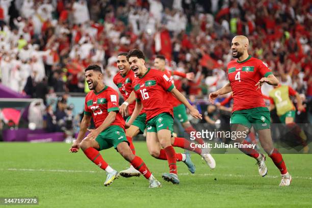 Morocco players celebrates after the team's victory in the penalty shoot out during the FIFA World Cup Qatar 2022 Round of 16 match between Morocco...