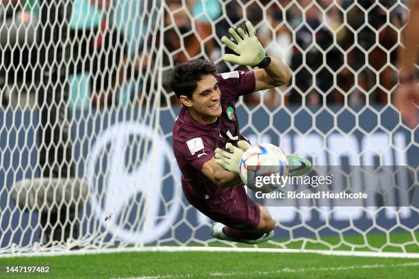 Yassine Bounou of Morocco saves the third penalty by Sergio Busquets of Spain in the penalty shoot out during the FIFA World Cup Qatar 2022 Round of...