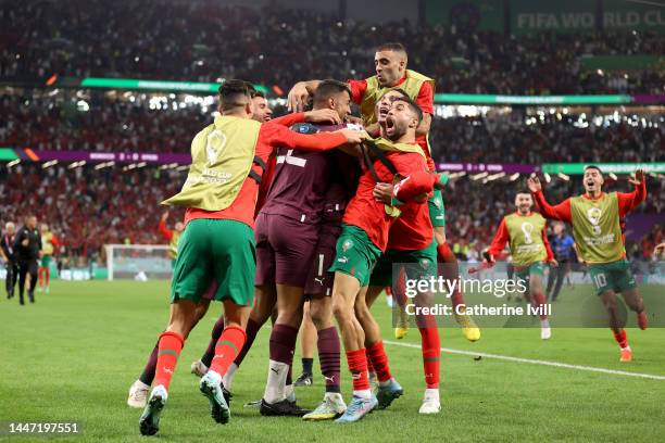 Morocco players celebrates after the team's victory in the penalty shoot out during the FIFA World Cup Qatar 2022 Round of 16 match between Morocco...