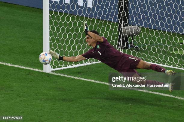 Yassine Bounou of Morocco saves the third penalty by Sergio Busquets of Spain in the penalty shoot out during the FIFA World Cup Qatar 2022 Round of...