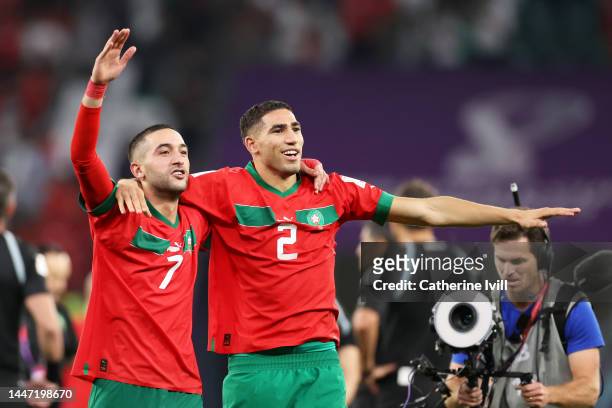 Hakim Ziyech and Achraf Hakimi of Morocco celebrate after the team's victory in the penalty shoot out during the FIFA World Cup Qatar 2022 Round of...
