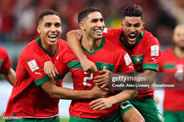 Achraf Hakimi of Morocco celebrates with teammates after scoring the winning penalty in the shootout during the FIFA World Cup Qatar 2022 Round of 16...