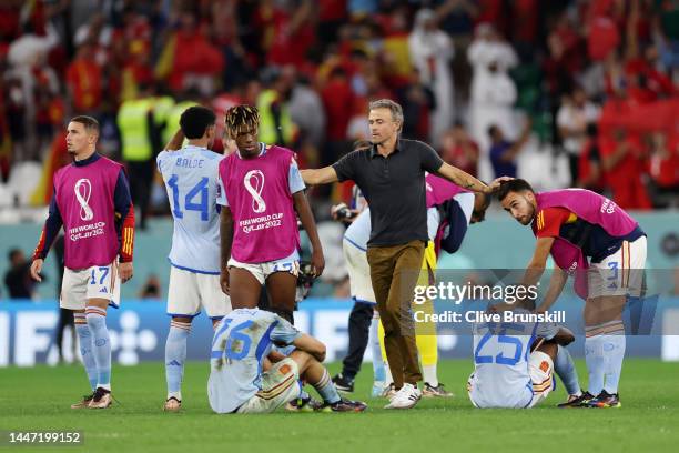 Spain players are consoled by Luis Enrique, Head Coach of Spain, after their defeat through the penalty shootout during the FIFA World Cup Qatar 2022...