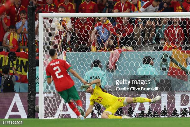 Achraf Hakimi of Morocco scores the team's fourth and winning penalty past Unai Simon of Spain in the penalty shoot out during the FIFA World Cup...