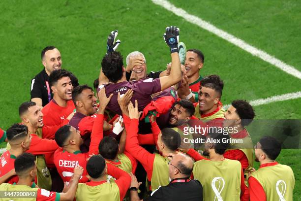 Yassine Bounou of Morocco celebrates with teammates after the penalty shootout win during the FIFA World Cup Qatar 2022 Round of 16 match between...
