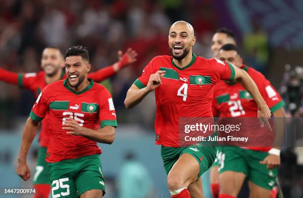 Yahya Attiat-Allah and Sofyan Amrabat of Morocco celebrate after their win in the penalty shoot out during the FIFA World Cup Qatar 2022 Round of 16...